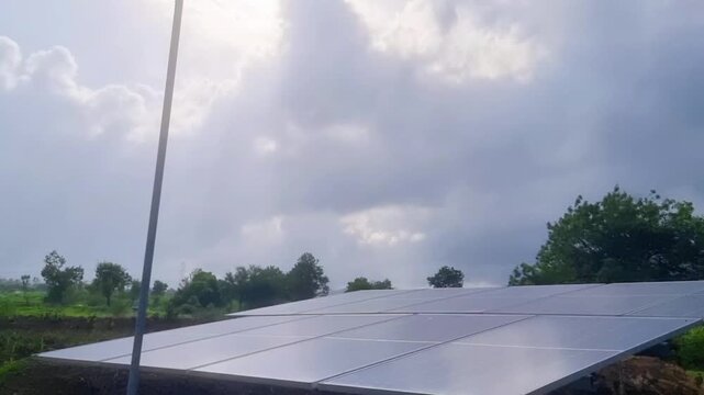 Sunlight streams through the clouds, striking a copper lightning rod antenna linked to ground-earthed solar panels, which convert the sun's energy into electricity for the farm.