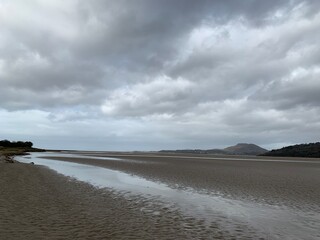 beach and clouds with view across the estuary 