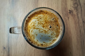 Close up image of a man and a woman clinking blue coffee mugs on wooden table