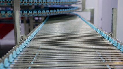Empty industrial conveyor belt moving through automated production line