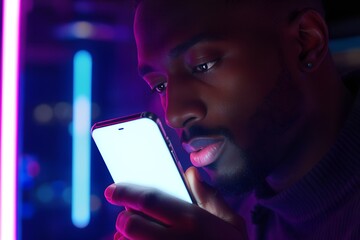 Young man intensely focused using his smartphone in a vibrant, neon-lit space, perfect for mobile tech, gaming, or social media concepts