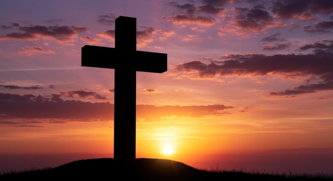Silhouette of a Christian cross against a vibrant sunset sky with orange and purple hues.