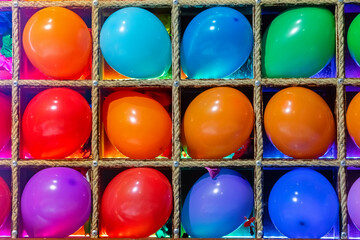 Inflated multicolored dart balls. Colorful balloons close-up. Darts at the fair in the amusement park