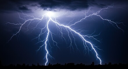 Powerful lightning strikes illuminate a dark, stormy night sky above a silhouetted landscape.