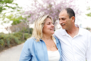 Fototapeta premium Marry me. Charming plump woman looks at her man. Middle age