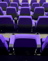 Empty purple cinema movie theater seats waiting for spectators