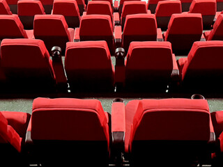 Empty red cinema movie theater seats waiting for spectators