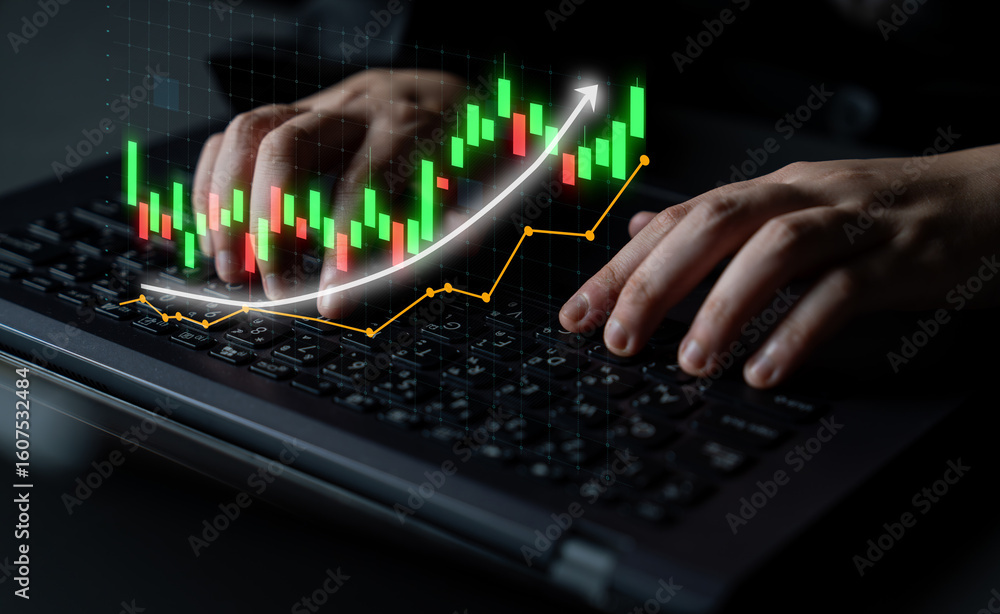 Poster a close-up view of hands working on a laptop keyboard with an overlay of a stock market chart, showi