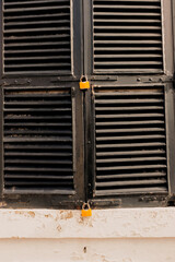 old door with closed shutters and padlock