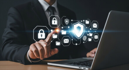 Businessman touching digital security icons on virtual screen while using laptop representing data protection cybersecurity privacy and secure online access system

