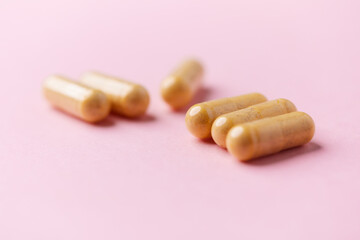 Vitamin B complex capsules on bright paper background. Soft focus. Close up. Copy space.	