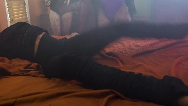 women writhes on a bed during an exorcism