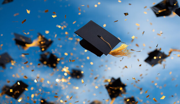 blue and gold graduation caps in the air with confetti on a blue sky background, creating an atmosphere of celebration for students who have just received their certificate or diploma from school,