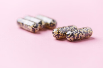 Iron capsules on bright background. Soft focus. Close up. Copy space.	