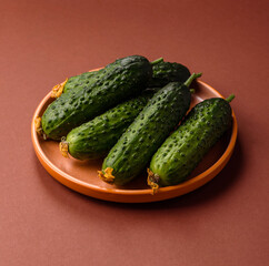 Fresh raw whole cucumbers, an ingredient for preparing salads and vegetarian dishes. Green fresh cucumbers