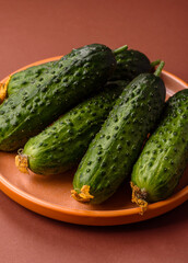 Fresh raw whole cucumbers, an ingredient for preparing salads and vegetarian dishes. Green fresh cucumbers