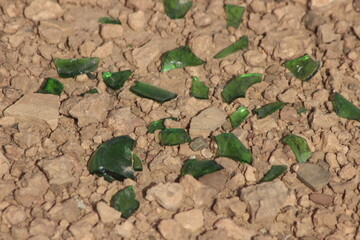 Green glass shards on the ground