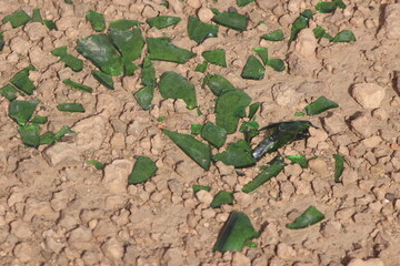 Green glass shards on the ground