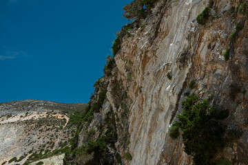 Low angle view of limestone cliff face showing dramatic vertical rock formations and textures