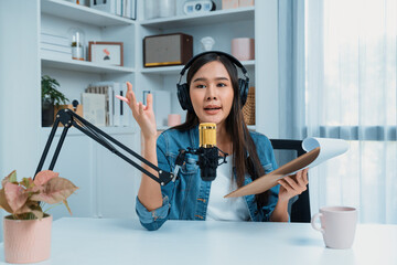 Host channel of young beautiful Asian wearing jeans creative broadcaster talking in online...