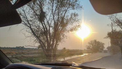 Sunset view, traveling by car on the highway, vacation trip, next to a river.