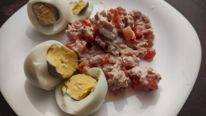 Healthy and delicious diet: lose weight with healthy foods, such as boiled egg and tuna with tomato and onion.