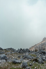 Mountain landscape completely enveloped in dense fog with minimal visibility