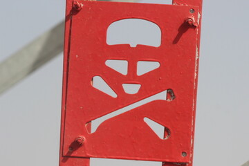A close up shot of a skull and crossbones sign, red danger sign, Warning sign