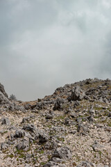 Wide view of rocky limestone landscape with scattered vegetation on Kefalonia island.