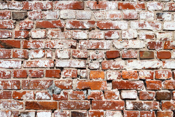 Dirty aged red brick wall background with spot white paint. Сloseup. Space for text.