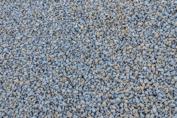 Top view of a gravel surface with mixed gray and beige stones, ideal as a construction background or copy space texture