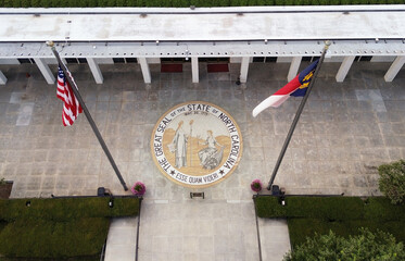 Aerial view of the North Carolina State legislature building with the state seal at the entrance