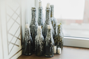 corked wine bottles decorated with melted candle wax