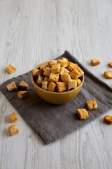 Homemade Crispy Bread Croutons in a Bowl, side view.