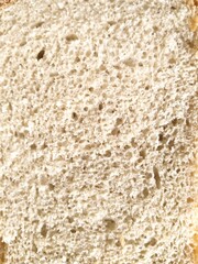 Close-up of white wheat bread slice texture.