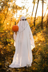 A ghost in orange headphones that are plugged into a pumpkin