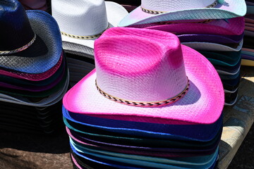 Stacks of cowboy hats for sale in every color.