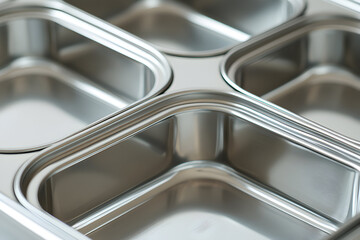 Close-up view of a metallic six-compartment food container.