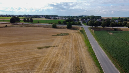 Drone flight over field of freshly harvested grain
