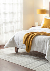 Modern Mid-Century bedroom design, a serene summer ambiance, cozy white bed, vibrant throw blanket, framed on a warm, naturally lit setting with sheer curtains, perfect relaxed and homey atmosphere.
