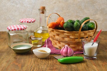 Prepared ingredients for making pickled cucumber and carrot salad on a wooden background. Home...