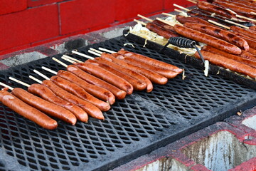 Long hot dogs on a stick being cooked at State Fair.