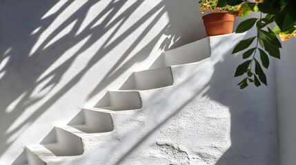 White fabric with leaf shadows cast on a gray wall.
