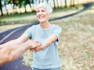 Happy active senior couple, portrait of an elderly woman with her husband dancing or swinging and...