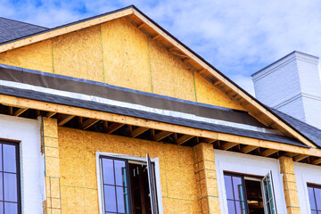 New construction features wooden framing open windows, reflecting progress under works day