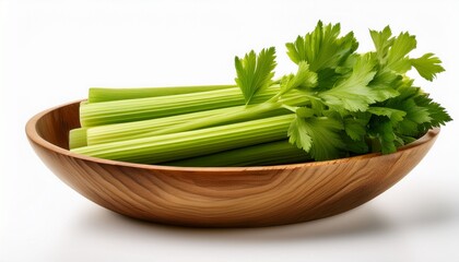 a bunch of fresh crisp green celery stalks in a wooden bowl for healthy eating isolated on a white background