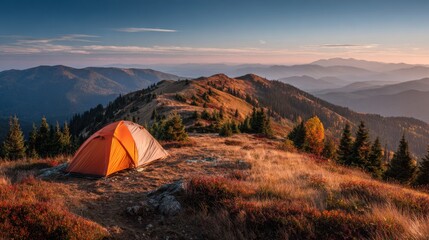 Tent on ridge with panoramic mountain view at sunrise