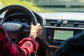 Woman driving car using gps navigation system on dashboard