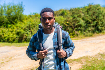 Young male hiker exploring nature trail on sunny day