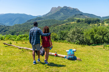 Hikers embracing majestic mountain view during summer trekking adventure